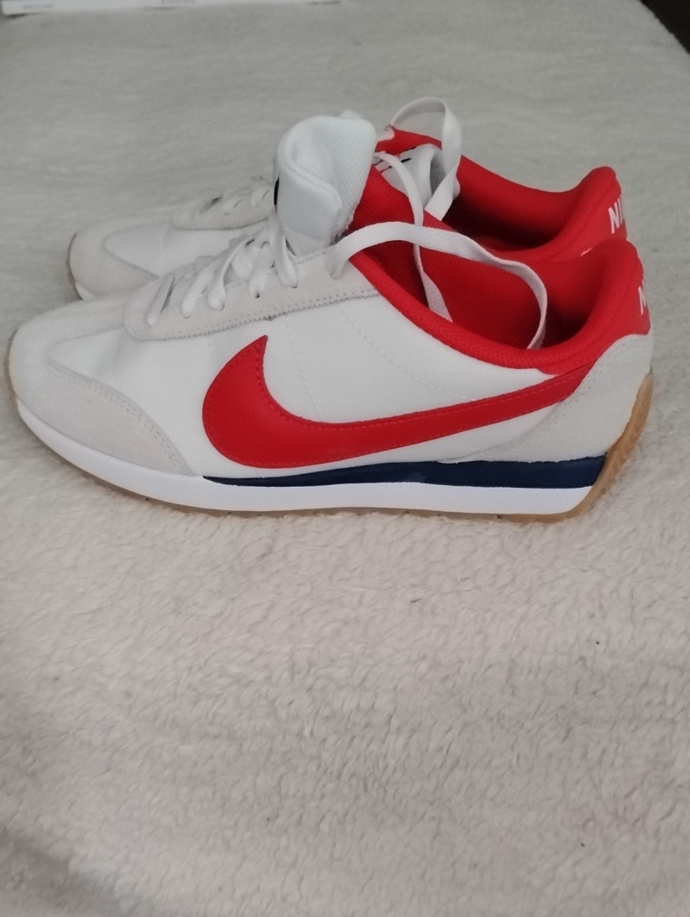 Nike Retro Style White Sneakers with Red Swoosh and Red Collar.